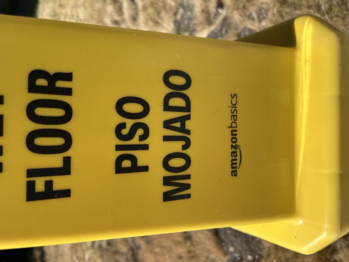 Amazon Basics wet floor sign — EXHIBIT B — PISO MOJADO