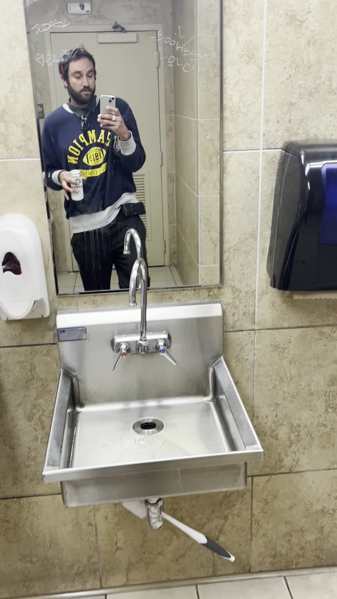 Robert Kochan — Vintage Champion, Italian trousers, handcrafted belt, draft ale, graffiti mirror — May 2026