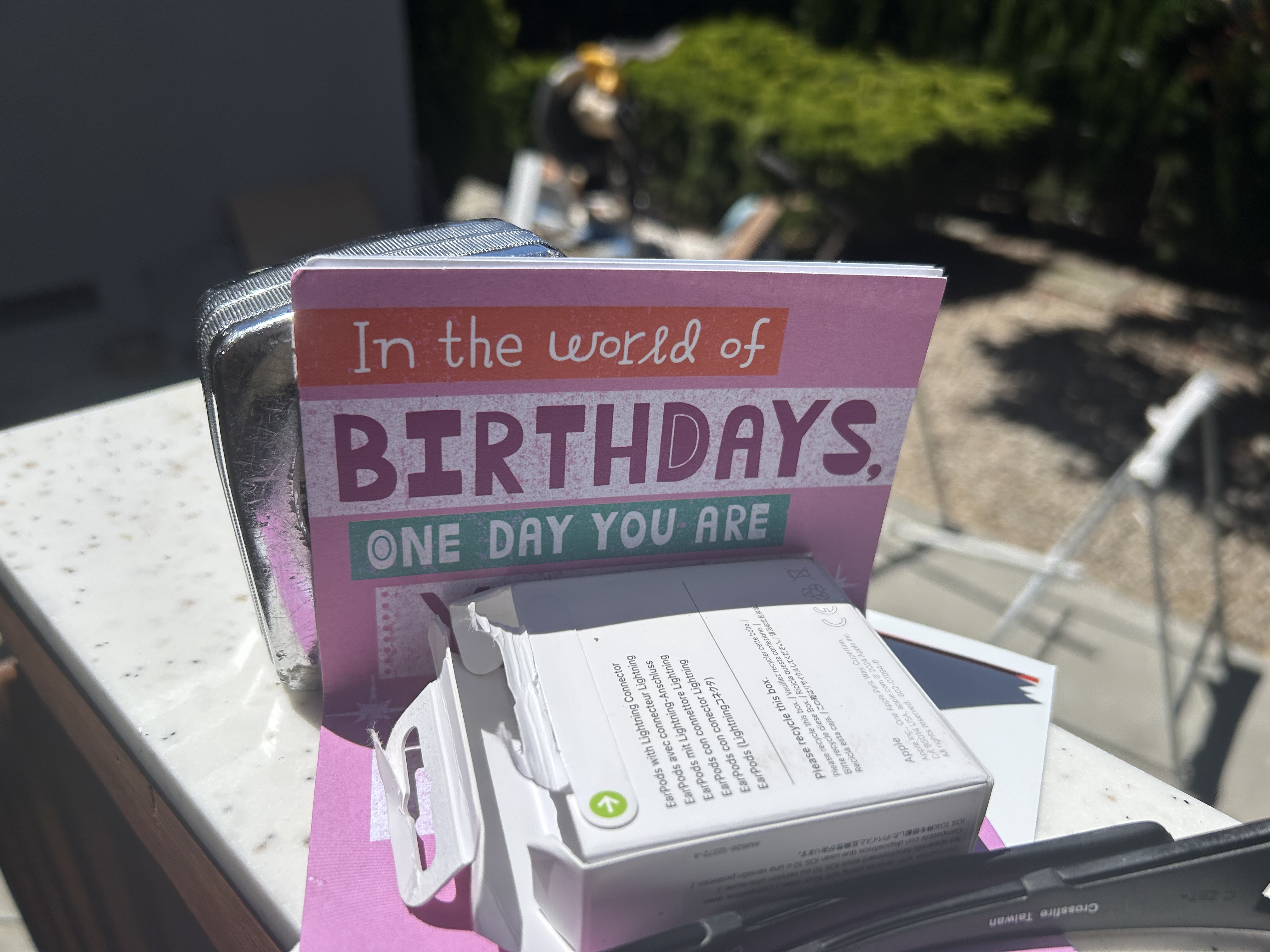 Birthday card and AirPods on McMorrow Rd deck