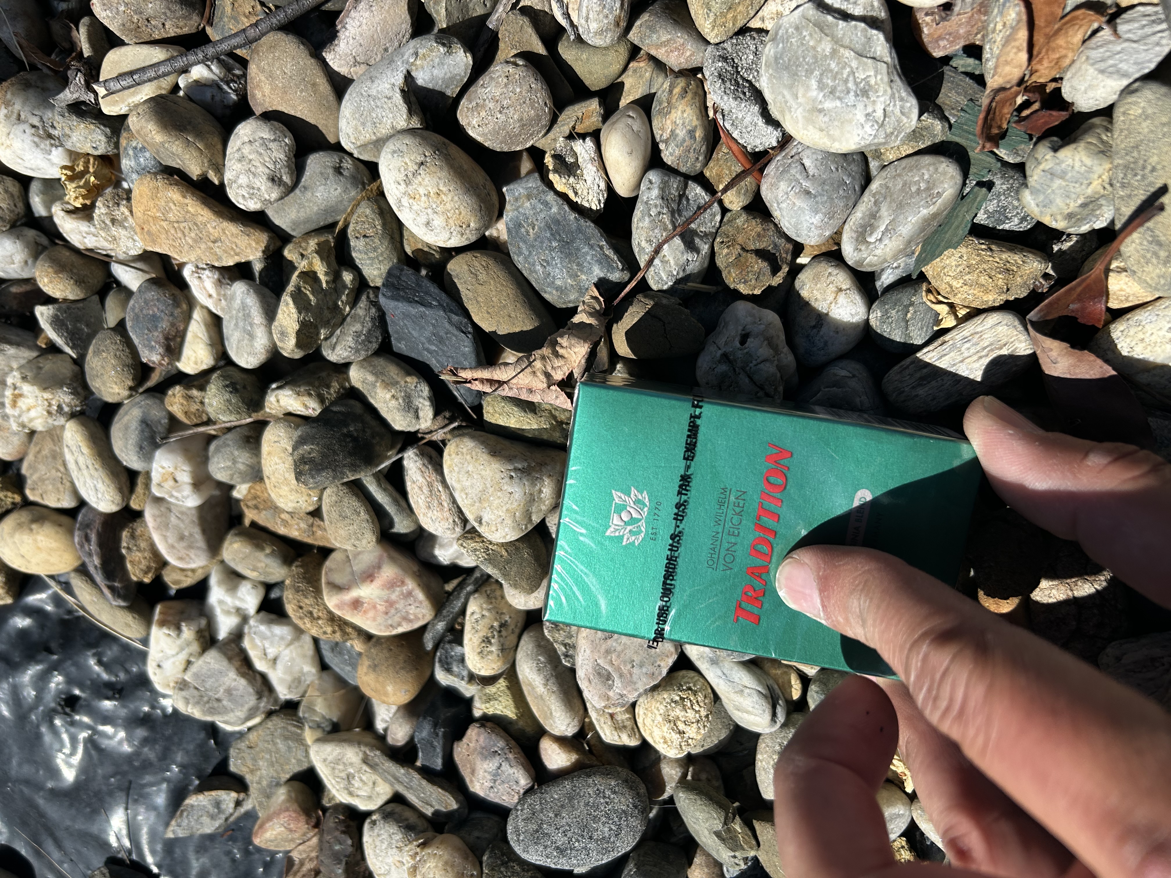 Johann Wilhelm Von Eicken TRADITION — side of pack visible — U.S. TAX EXEMPT FOR USE OUTSIDE stamped — held over river rocks — East Bay 925