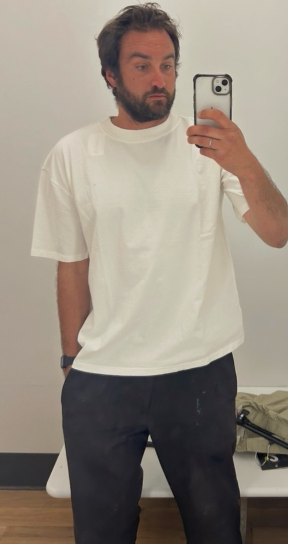 Robert Kochan — VUES white oversized tee — perfect weight — perfect neck — dark pants — mirror selfie — East Bay — May 2026 — 925