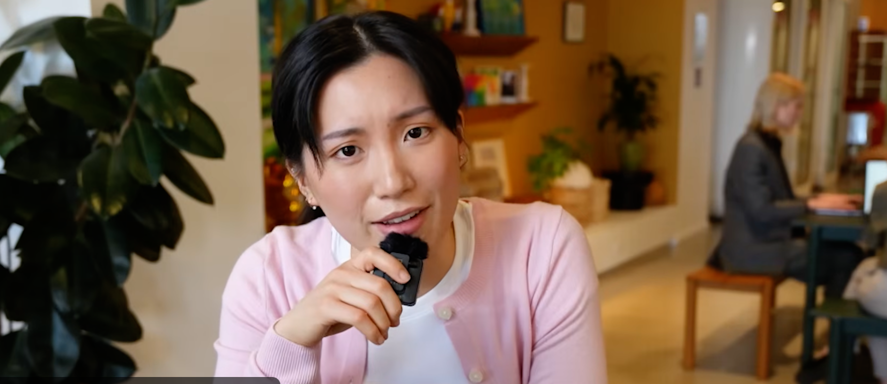 YouTuber holding microphone to face — the credential