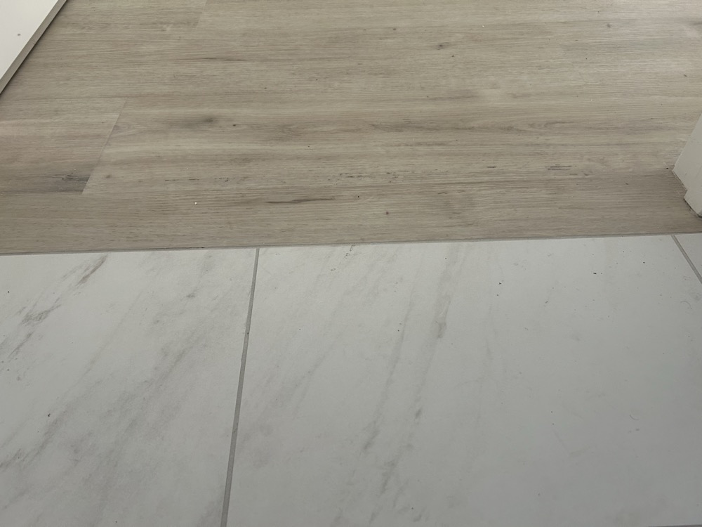 Floor transition — LVP to marble porcelain, Artisan Tile Co.