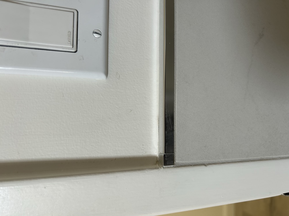 Chrome transition strip detail — Artisan Tile Co.