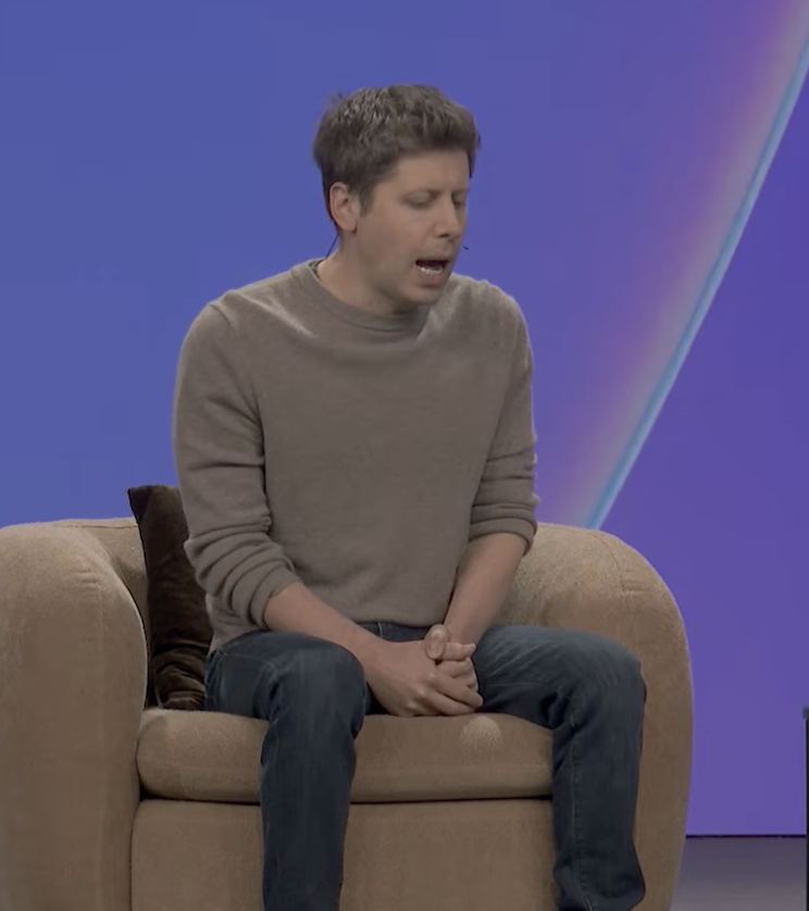 Sam Altman — eyes half-closed, mid-search, mouth open, hands still clasped
