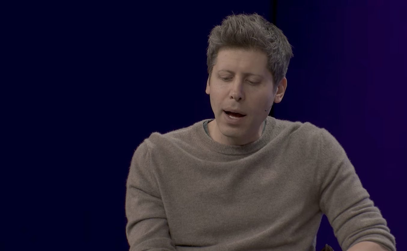 Sam Altman — eyes down, self-deprecating before the question, the tell is there