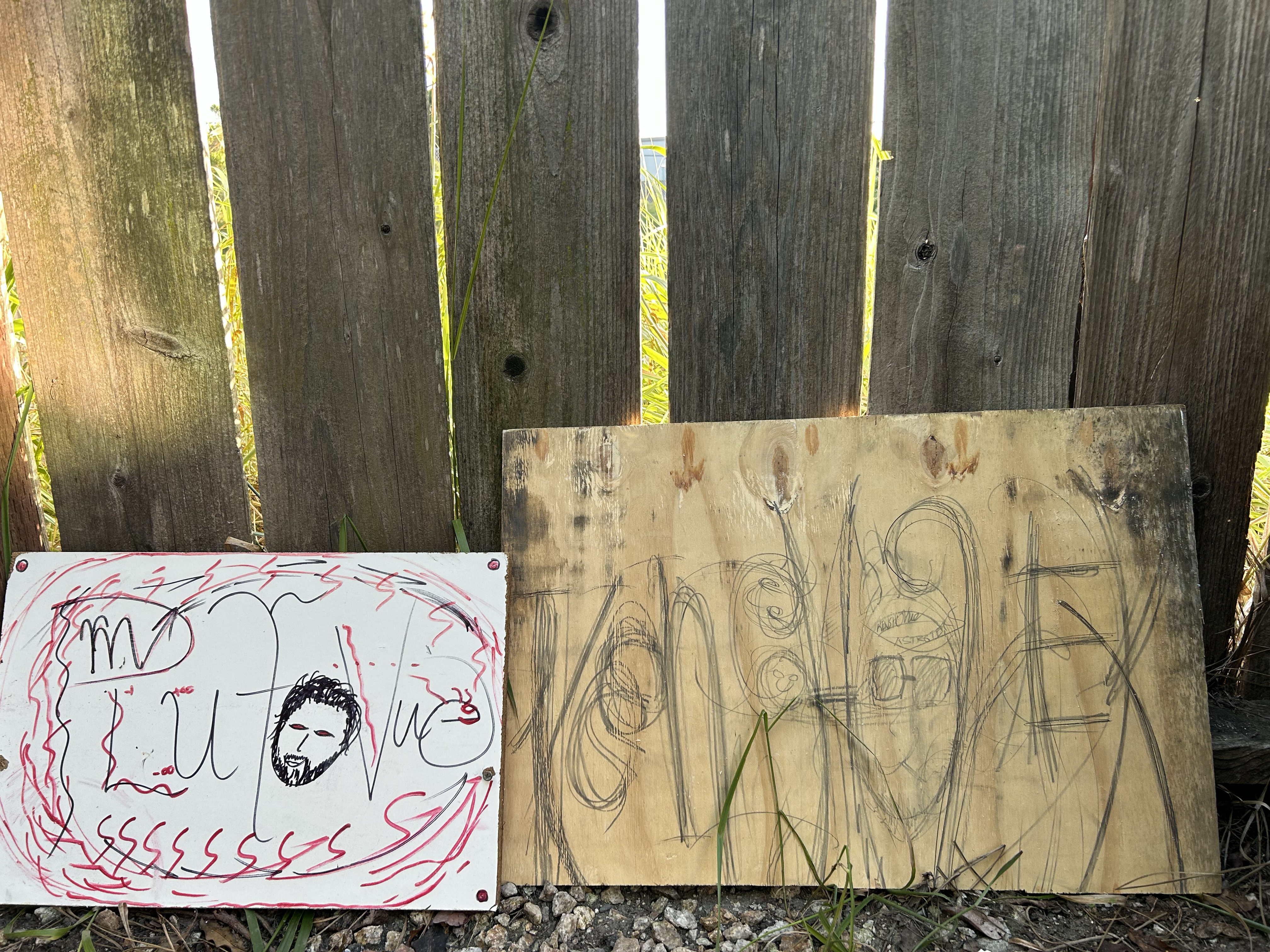 KenshoTek Woodshop — hand-drawn signs on raw plywood leaning against fence — pre-polyurethane — actual footage